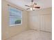 Bright bedroom with large window, ceiling fan and double closet doors at 5080 Timber Chase Way, Sarasota, FL 34238