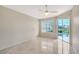 Bright, airy bedroom with sliding glass doors leading to the pool area and neutral color palette at 5080 Timber Chase Way, Sarasota, FL 34238