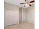 Bedroom with tile floors, bi-fold closet doors, and a ceiling fan at 5080 Timber Chase Way, Sarasota, FL 34238