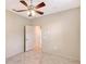 Bedroom featuring tiled floors, neutral paint, and ceiling fan at 5080 Timber Chase Way, Sarasota, FL 34238