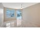Well-lit bedroom featuring tile flooring, a ceiling fan, and a view of the pool area at 5080 Timber Chase Way, Sarasota, FL 34238