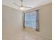 Bedroom with a ceiling fan, tiled floor, and a window with curtains at 5080 Timber Chase Way, Sarasota, FL 34238