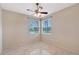 Well-lit bedroom with tile flooring and a beautiful view of the lake from the windows at 5080 Timber Chase Way, Sarasota, FL 34238
