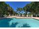 Inviting community pool with sun loungers and lush landscaping offering a relaxing atmosphere at 5080 Timber Chase Way, Sarasota, FL 34238