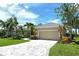 Inviting single-story home featuring a paver driveway, tan exterior, and tile roof at 5080 Timber Chase Way, Sarasota, FL 34238