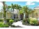 Beautiful home entrance framed by lush landscaping, palm trees, and a stone walkway at 5080 Timber Chase Way, Sarasota, FL 34238