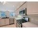 Modern kitchen with stainless appliances, white cabinets, and granite countertops at 5080 Timber Chase Way, Sarasota, FL 34238