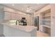 Bright kitchen features white cabinets, stainless steel appliances, and a breakfast bar at 5080 Timber Chase Way, Sarasota, FL 34238