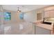 Bright living room features tile floors, ceiling fan, and a kitchen bar overlooking the sink at 5080 Timber Chase Way, Sarasota, FL 34238