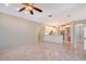 Open-concept living room with tile floors is adjacent to a kitchen with stainless steel appliances at 5080 Timber Chase Way, Sarasota, FL 34238