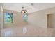 Bright living room with tile floors, ceiling fan, and large windows with a view of the lake at 5080 Timber Chase Way, Sarasota, FL 34238