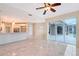 Open-concept living space featuring tile flooring, ceiling fan and access to a screened lanai at 5080 Timber Chase Way, Sarasota, FL 34238