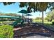 Community playground featuring slides, climbing structures, and shaded seating for Gathering fun at 5080 Timber Chase Way, Sarasota, FL 34238