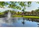 Scenic view of the Turtle Rock pond featuring a water fountain and trellised walkway at 5080 Timber Chase Way, Sarasota, FL 34238