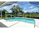 Screened-in pool with clear blue water and lush landscaping around at 5080 Timber Chase Way, Sarasota, FL 34238
