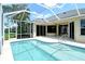 Backyard pool featuring a screened enclosure and a view of the house at 5080 Timber Chase Way, Sarasota, FL 34238
