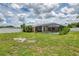 Spacious backyard with a screened-in pool, complemented by green lawn and privacy fencing at 5124 Palm Aire Dr, Sarasota, FL 34243