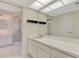 Bathroom with tiled floor, wide mirror, and walk-in shower stall at 5124 Palm Aire Dr, Sarasota, FL 34243