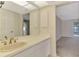 Bathroom with tiled floor, vanity, and view into adjacent carpeted room at 5124 Palm Aire Dr, Sarasota, FL 34243