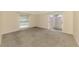 Bedroom featuring carpet, white trim, and a sliding glass door with access to the backyard at 5124 Palm Aire Dr, Sarasota, FL 34243