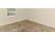 Bedroom featuring tile floors, white trim, and a bright window with a view of the yard at 5124 Palm Aire Dr, Sarasota, FL 34243