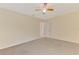 Spacious bedroom features neutral walls, carpet floors, and a colorful ceiling fan at 5124 Palm Aire Dr, Sarasota, FL 34243