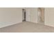 Carpeted bedroom featuring two doors leading to other rooms at 5124 Palm Aire Dr, Sarasota, FL 34243