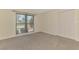 Carpeted bedroom featuring large window and closet with bi-fold doors at 5124 Palm Aire Dr, Sarasota, FL 34243