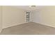 Bedroom featuring carpet, large window, and closet with bifold doors at 5124 Palm Aire Dr, Sarasota, FL 34243