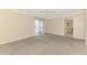 Bedroom with carpet, sliding glass door to outside area, and ensuite bathroom entrance at 5124 Palm Aire Dr, Sarasota, FL 34243