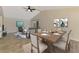 An elegant dining area featuring a wooden table and seating for six, blending seamlessly into the living room at 5124 Palm Aire Dr, Sarasota, FL 34243