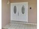 Elegant double front doors with decorative glass inserts for a welcoming entry at 5124 Palm Aire Dr, Sarasota, FL 34243