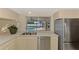 Bright kitchen featuring stainless steel appliances and a view of the screened-in pool at 5124 Palm Aire Dr, Sarasota, FL 34243