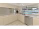 Bright kitchen featuring stainless steel appliances and a view of the screened-in pool at 5124 Palm Aire Dr, Sarasota, FL 34243