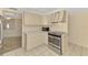 Well-lit kitchen with stainless steel appliances and ample cabinet space at 5124 Palm Aire Dr, Sarasota, FL 34243