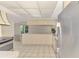 Open concept kitchen featuring stainless steel appliances and a view of the dining area at 5124 Palm Aire Dr, Sarasota, FL 34243