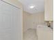 Bright laundry room with tile floors and closet with access to the exterior at 5124 Palm Aire Dr, Sarasota, FL 34243