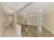 Spacious living room with elegant tile flooring and open access to adjacent rooms and doorways at 5124 Palm Aire Dr, Sarasota, FL 34243