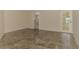 Open living area with stylish tile flooring, light walls, and access to the patio area at 5124 Palm Aire Dr, Sarasota, FL 34243