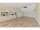 Open-concept living room with a spacious layout, neutral tones, and lots of natural light from large windows at 5124 Palm Aire Dr, Sarasota, FL 34243