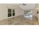 Bright living room with large windows and sliding doors, providing natural light and access to the backyard at 5124 Palm Aire Dr, Sarasota, FL 34243