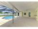 Relaxing screened-in lanai with a refreshing swimming pool and lots of open space at 5124 Palm Aire Dr, Sarasota, FL 34243