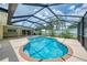 Aerial view of refreshing in-ground pool with screened in enclosure and covered patio at 5124 Palm Aire Dr, Sarasota, FL 34243