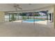 Relaxing screened-in lanai with a refreshing swimming pool and lots of open space at 5124 Palm Aire Dr, Sarasota, FL 34243