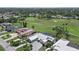Aerial view of home near golf course, pool, mature landscaping at 538 Magellan Dr, Sarasota, FL 34243