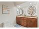 Bathroom featuring double sink, granite countertop, and dark wood cabinetry at 538 Magellan Dr, Sarasota, FL 34243