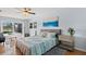 Cozy bedroom features sliding glass door to a screened pool at 538 Magellan Dr, Sarasota, FL 34243