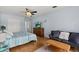 Comfortable bedroom featuring a ceiling fan, hardwood floors, and modern decor at 538 Magellan Dr, Sarasota, FL 34243