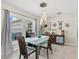 Elegant dining room with a glass table and modern chandelier at 538 Magellan Dr, Sarasota, FL 34243