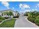 Long driveway leading to a well-maintained home, lush greenery, and manicured landscaping at 538 Magellan Dr, Sarasota, FL 34243